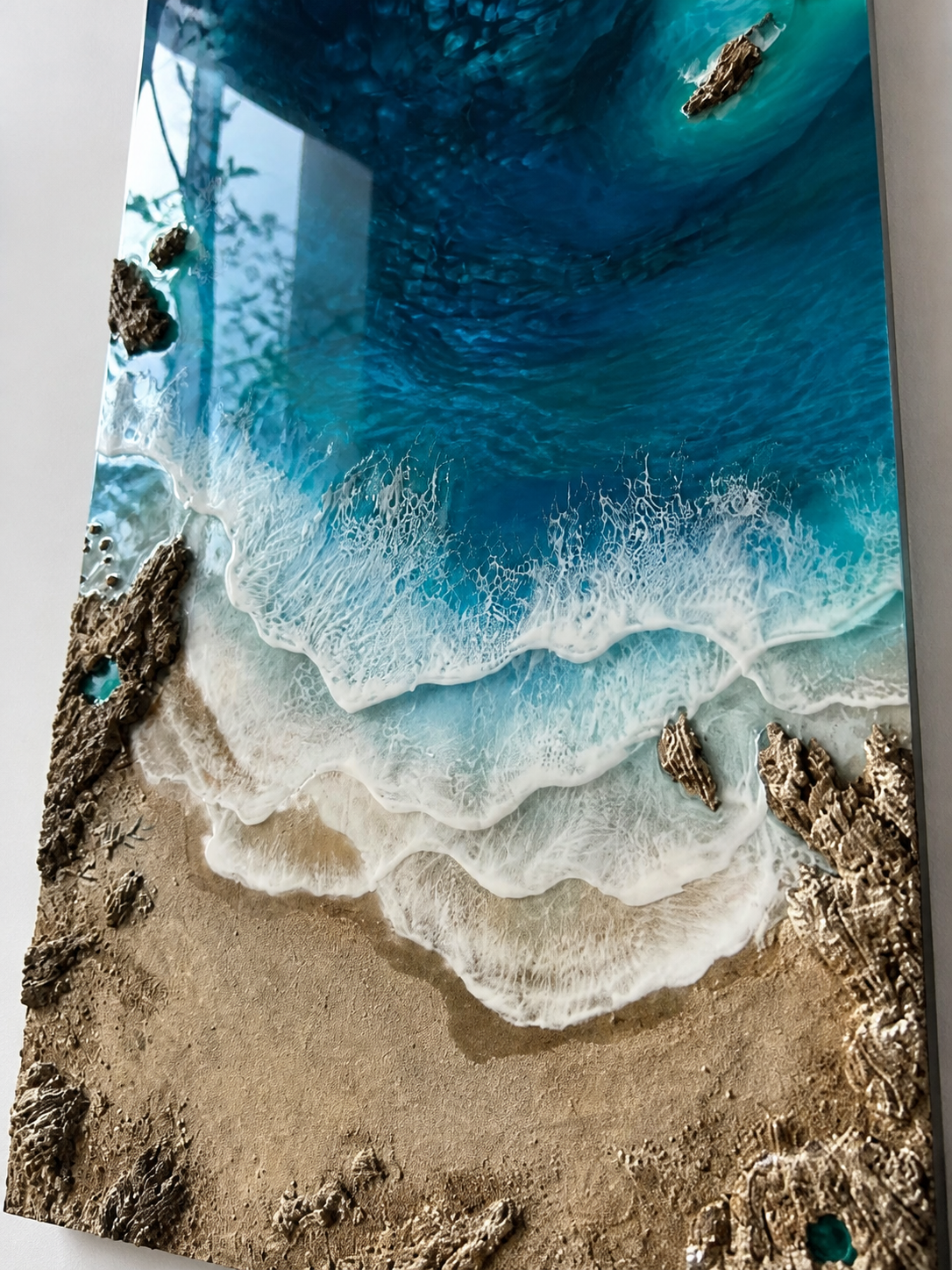 Close-up of layered resin ocean waves and coastal textures