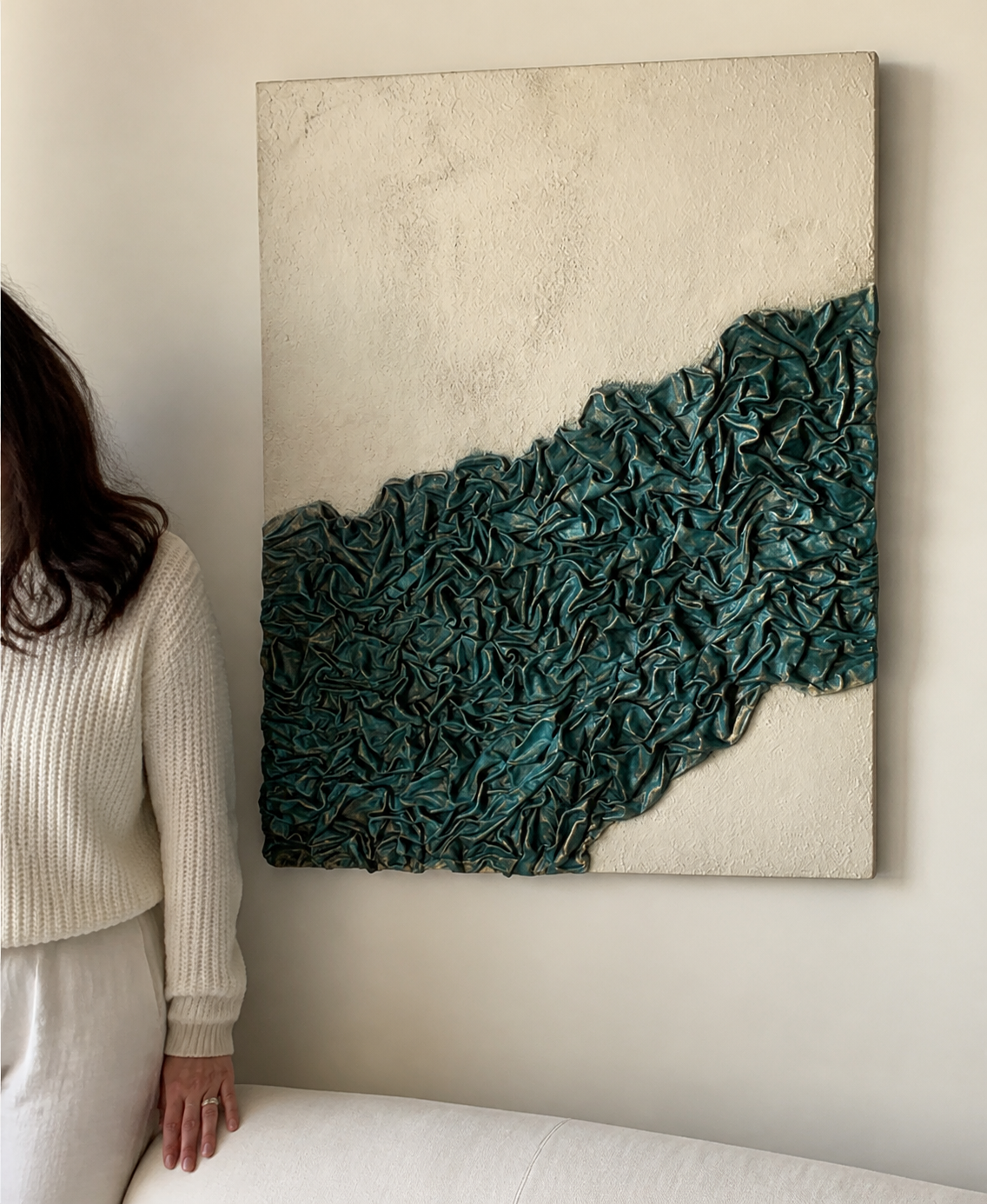 Minimalist 3D textured fabric wall art hung vertically above wooden console table in foyer
