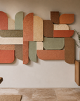 Oversized colorful geometric 3D relief mural styled above sofa in luxury modern penthouse