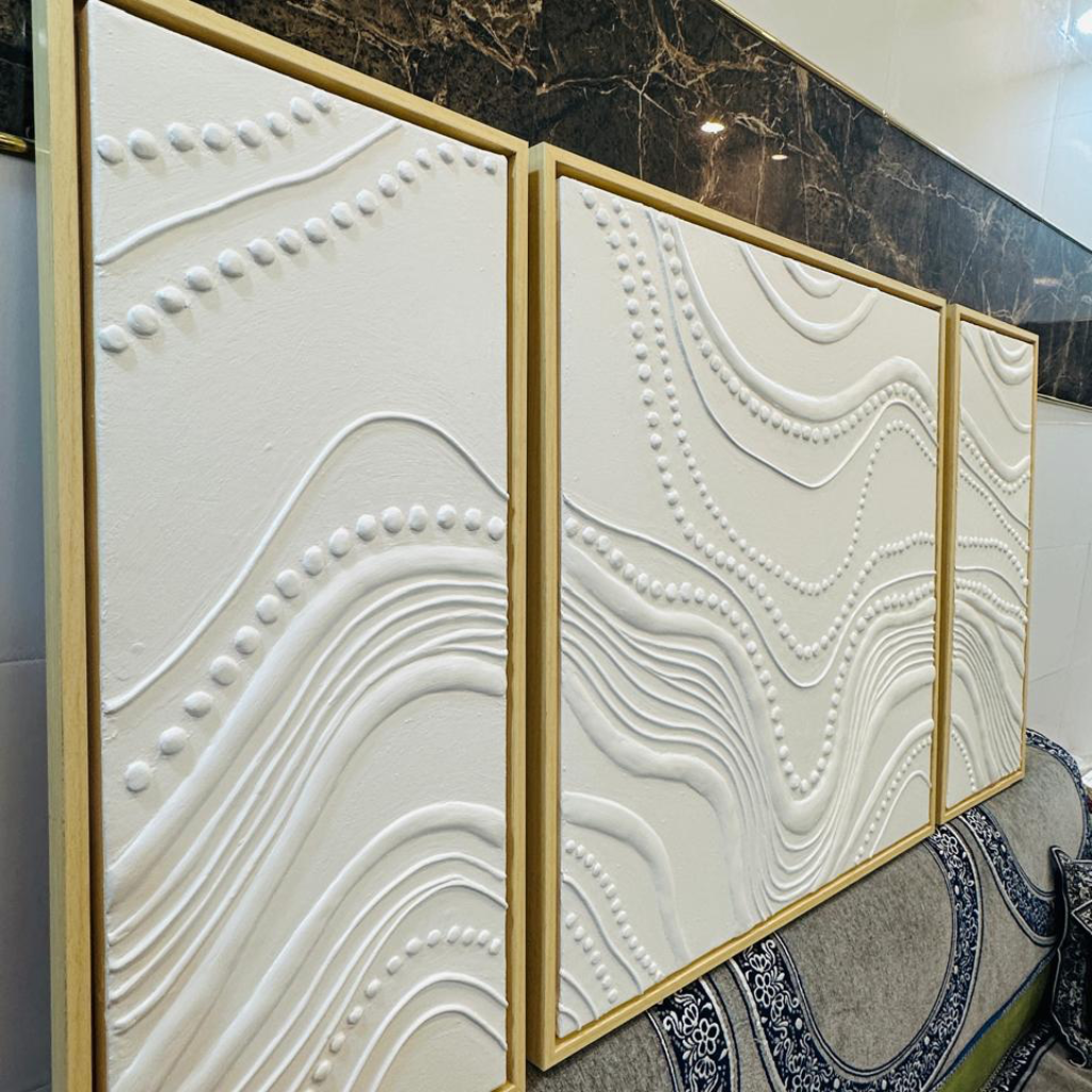 Decorative wall panels with textured design on a marble surface