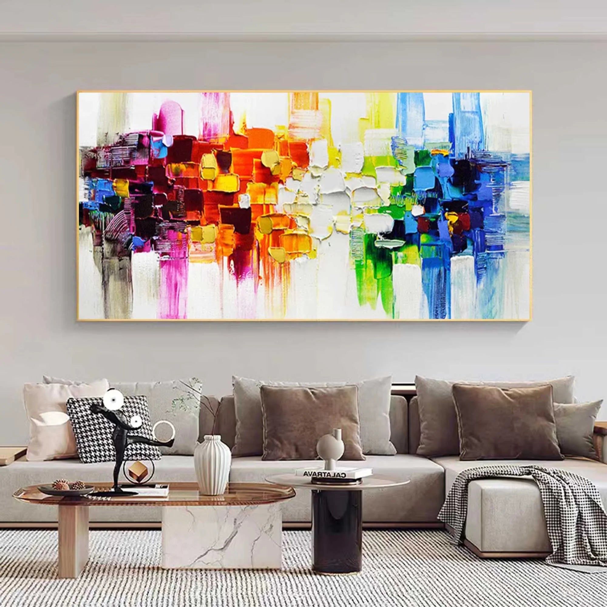 Colorful abstract painting on a wall above a sofa in a living room.