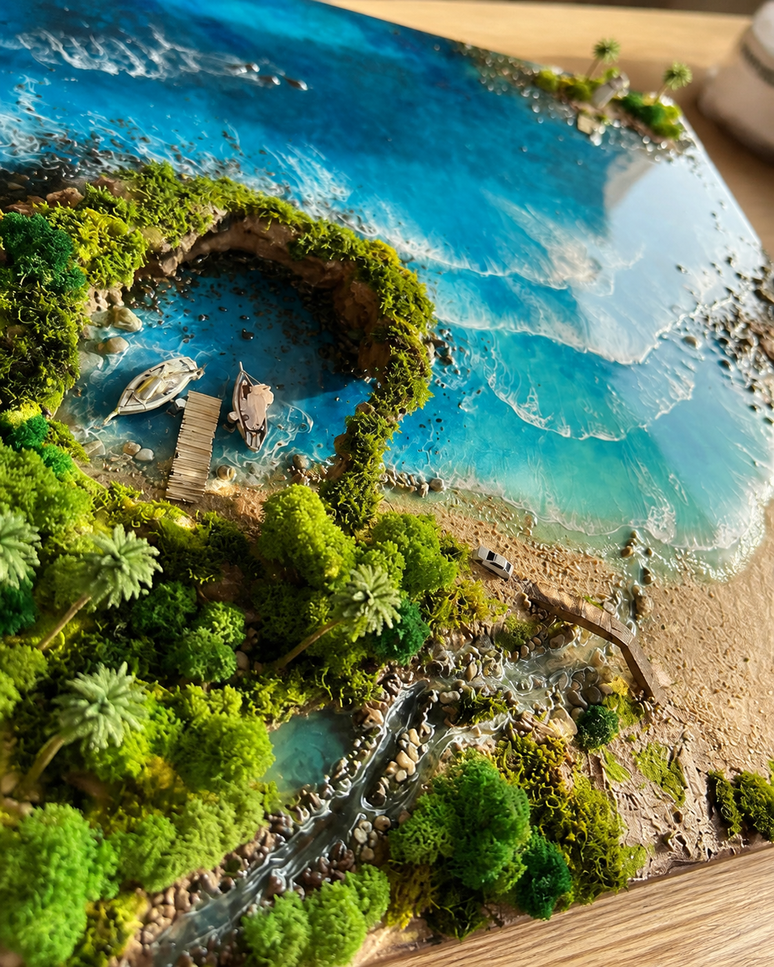 3D resin lagoon landscape with turquoise water, tropical greenery and wooden boats