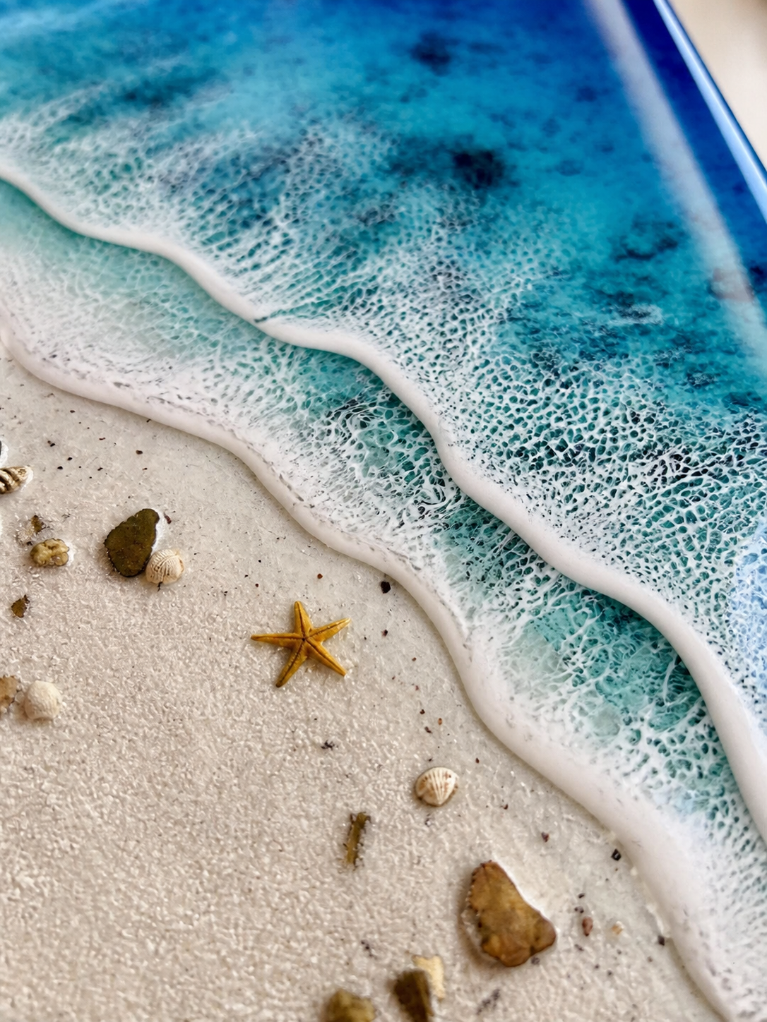 Resin beach artwork with shells stones and starfish