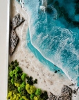 Close up of handcrafted turquoise ocean resin art with textured beach and rocks